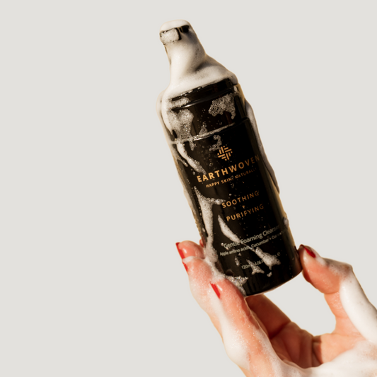Earthwoven Gentle Foaming Cleanser in hand with soap-free foam, ideal for sensitive, acne-prone skin.