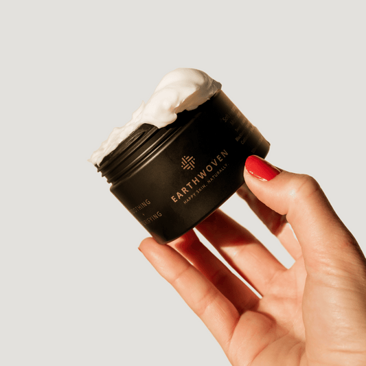 Earthwoven Soft Hydrating Moisturizer in hand with visible cream texture, ideal for soothing eczema-prone and sensitive skin.